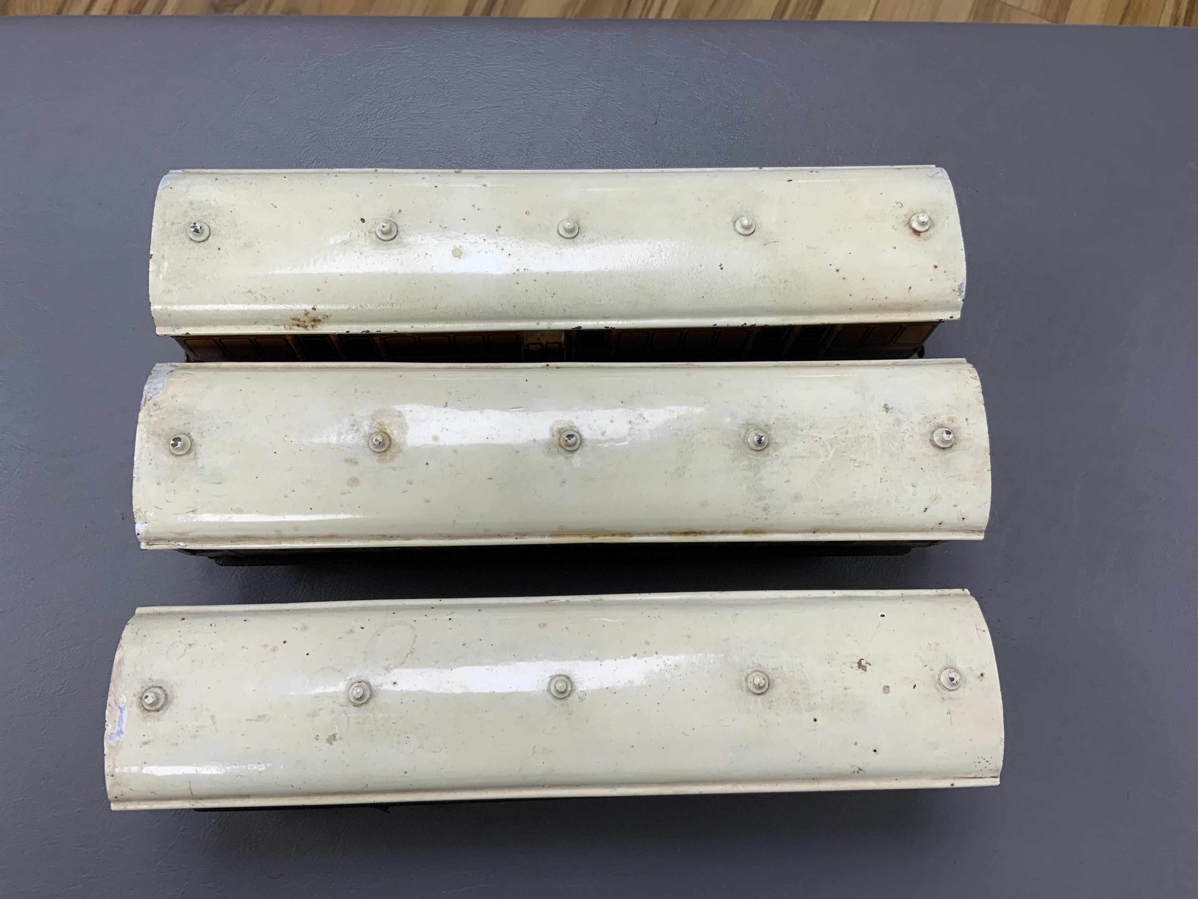 Three Carette for Bassett-Lowke 0 gauge railway 1921 series tinplate LSWR bogie coaches fitted with Bing couplings; two First Third Composite coaches, both 1328, and a full brake van, 133, all in salmon and chocolate liv